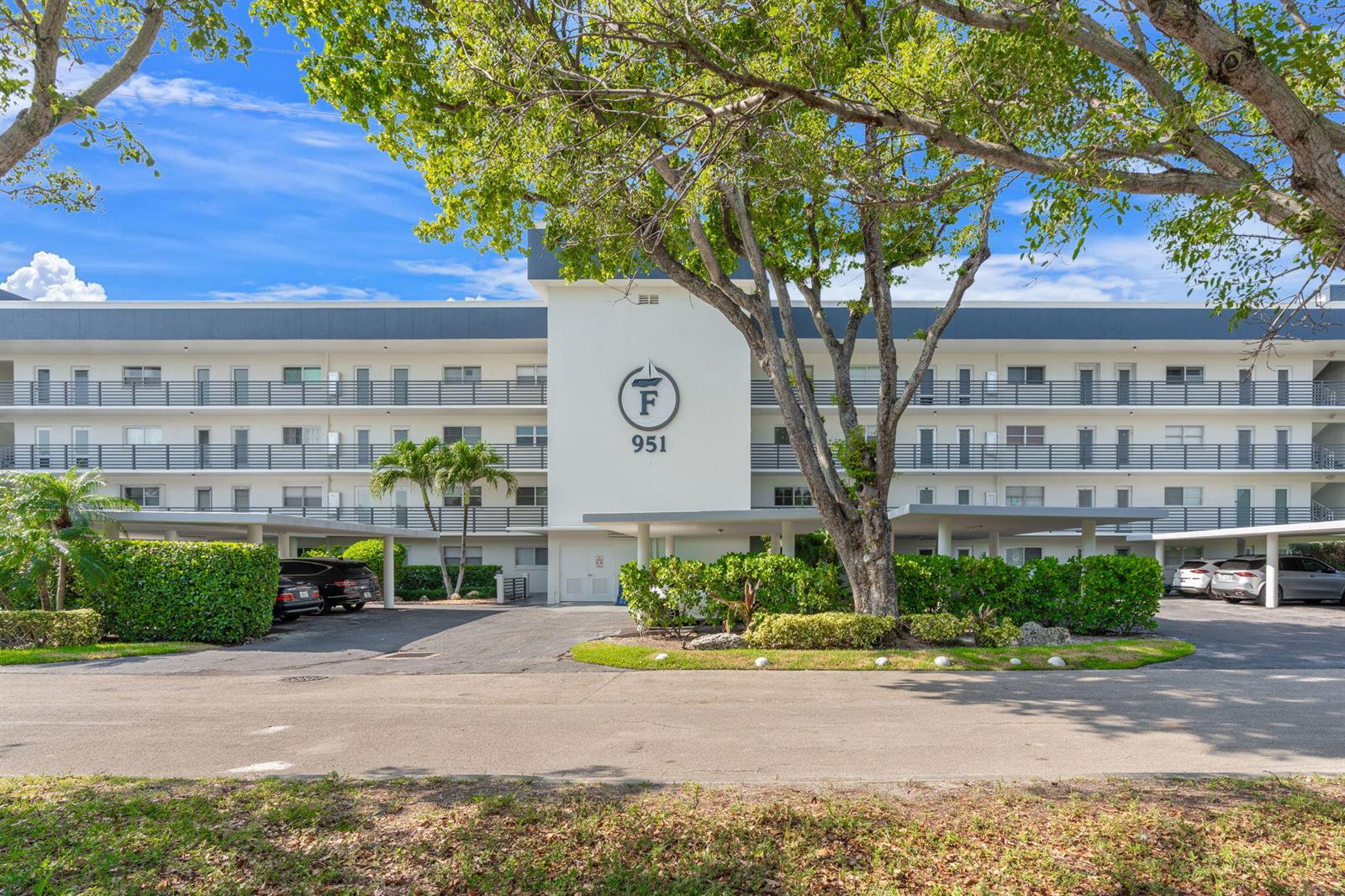 A three-story apartment building with a central entrance marked with the letter F and 951 — 951 Spanish Circle # 346, Delray Beach FL 33483, DELRAY BEACH, FL