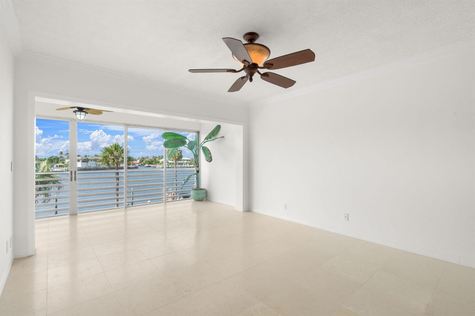 An empty room with light tile floors, a ceiling fan, and a sliding glass door balcony — 951 Spanish Circle # 346, Delray Beach FL 33483, DELRAY BEACH, FL