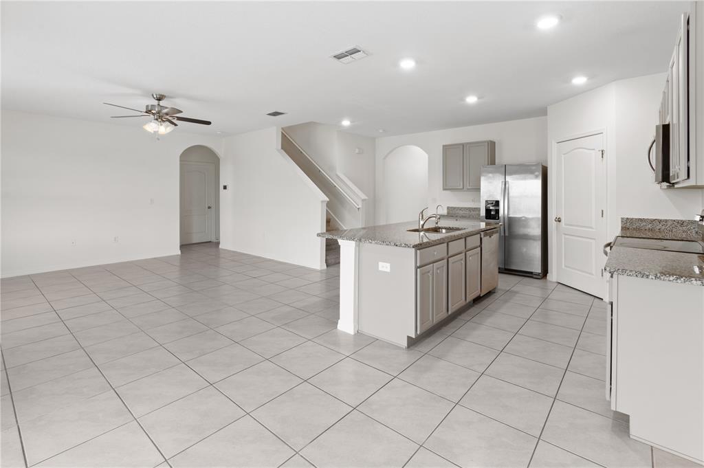 A two-story house with a light-colored stucco exterior, a two-car garage, and green shutters — 2651 GRANDBURY GROVE ROAD, LAKELAND, FL