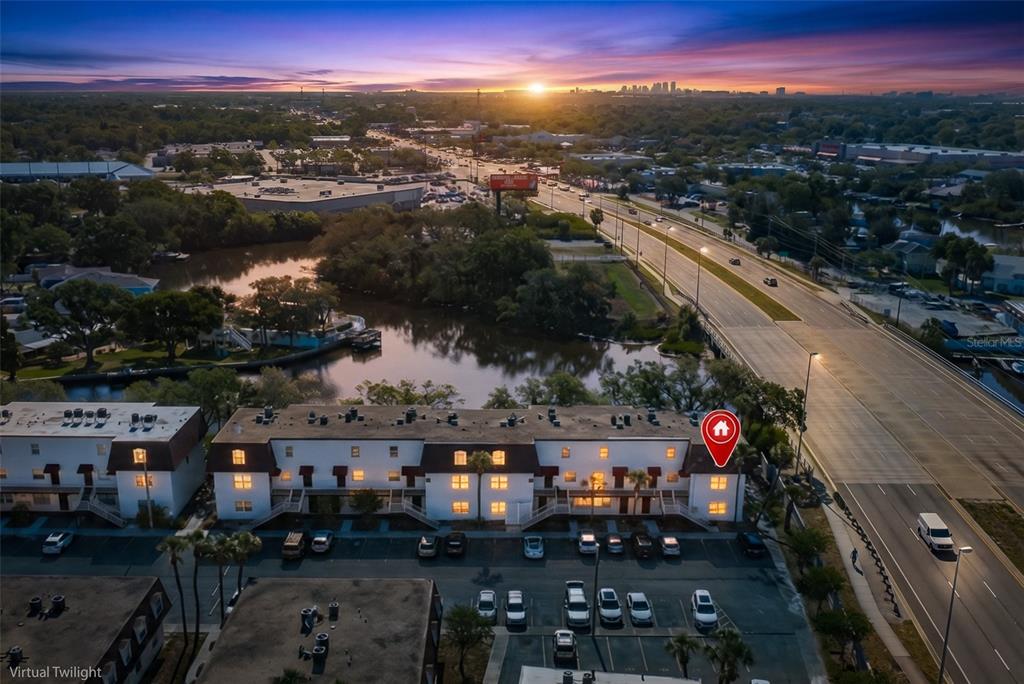 An aerial view shows a multi-story apartment building with a red location pin — 9001 TUDOR DRIVE UNIT H210, TAMPA, FL