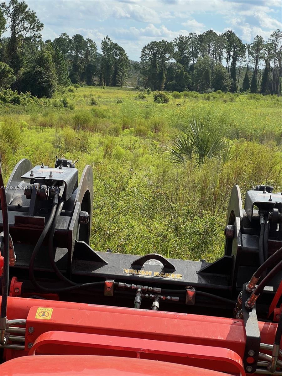 A view from the operator's seat of a tractor equipped with a brush rake attachment — Huntington Shortcut Rd, Cresent City FL 32112, CRESENT CITY, FL