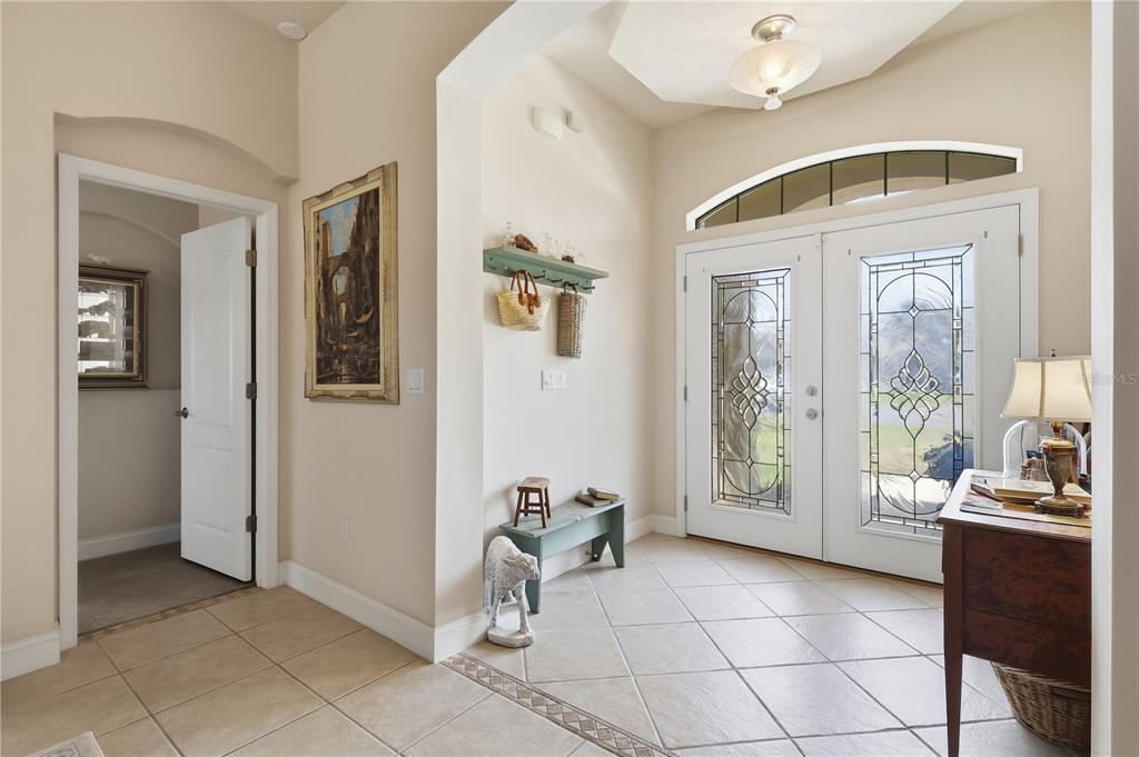 An entryway features tile flooring, a double front door with glass inserts, and a wall shelf — 36 LANCASTER LANE, PALM COAST, FL
