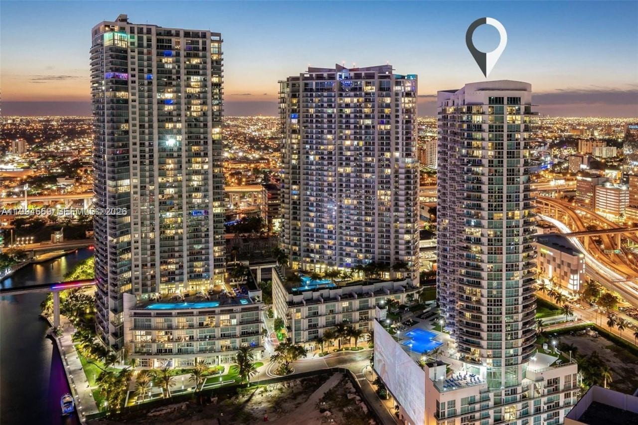 An aerial view of three high-rise residential towers with swimming pools at sunset — 350 S Miami Ave # 2714, Miami FL 33130, MIAMI, FL