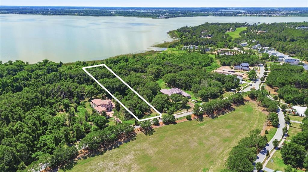An aerial view shows a rectangular plot of land outlined in white near a lake — 17119 ETRUSCAN LANE, MONTVERDE, FL