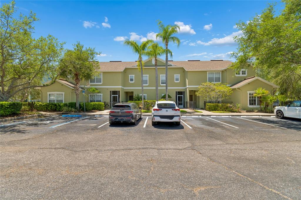 A two-story apartment building with a parking lot in the foreground — 10925 WINTER CREST DRIVE, RIVERVIEW, FL