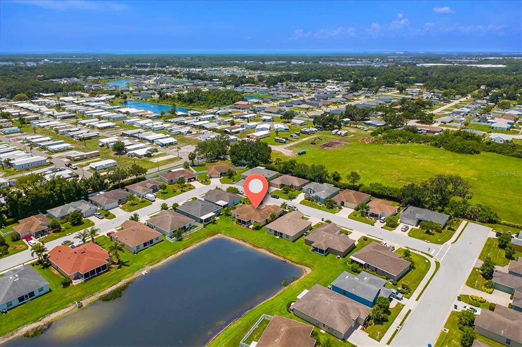 An aerial view shows a residential neighborhood with a house marked by a location pin — 3215 55TH STREET E, PALMETTO, FL