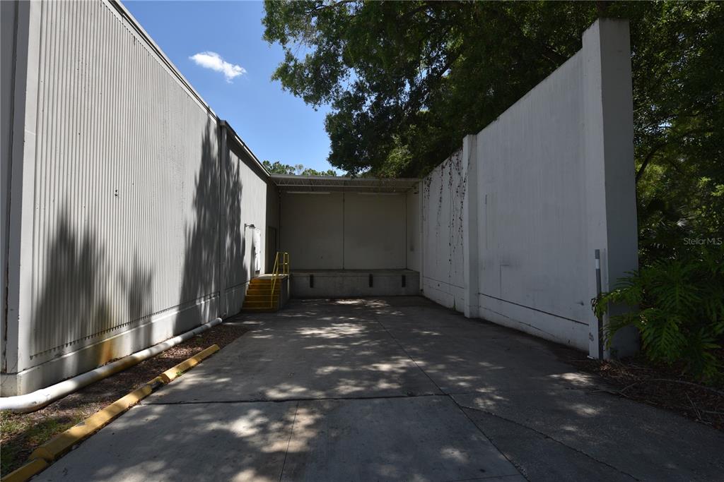 An exterior view of a loading dock area between two industrial building walls — 1211 TECH BOULEVARD UNIT 169, TAMPA, FL