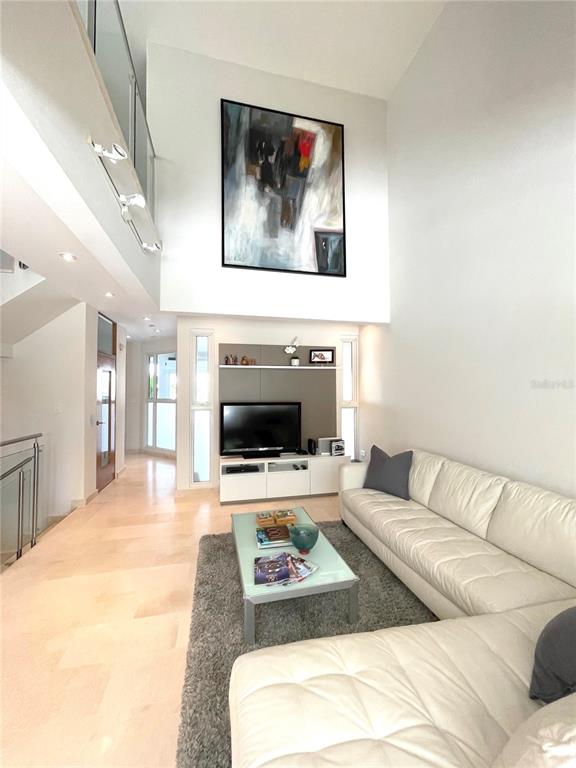 A living room features high ceilings, a large abstract painting, and a white sectional sofa — 14 PENINSULA  DE SAN JUAN STREET, HUMACAO, PR