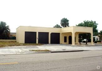 A single-story commercial building with three garage doors and a covered drive-through area — 3712 S Olive Ave, West Palm Beach FL 33405, WEST PALM BEACH, FL