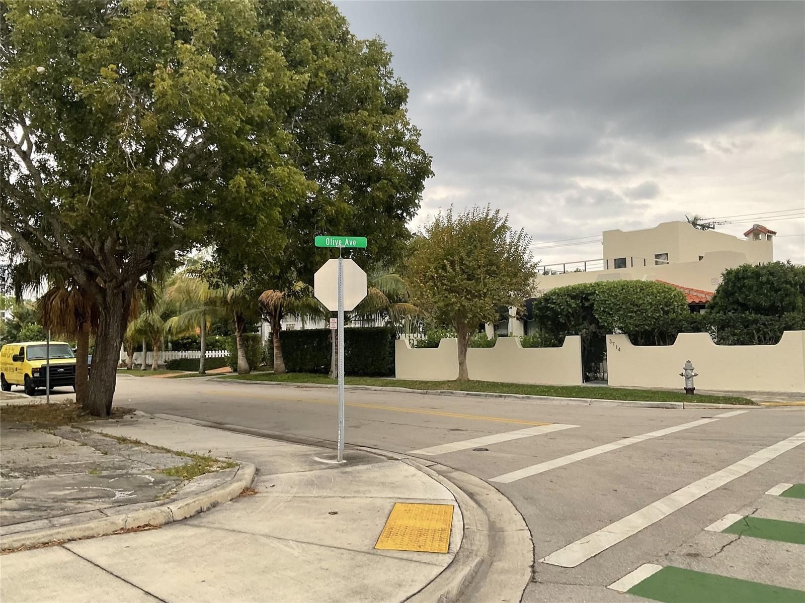 A street corner with a stop sign, a street sign, and a yellow van — 3712 S Olive Ave, West Palm Beach FL 33405, WEST PALM BEACH, FL