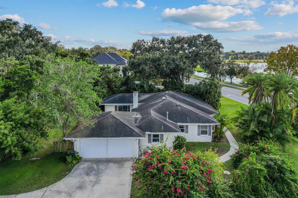 An aerial view of a single-story house with a two-car garage and a paved driveway — 225 LAKE HOLLINGSWORTH DRIVE, LAKELAND, FL