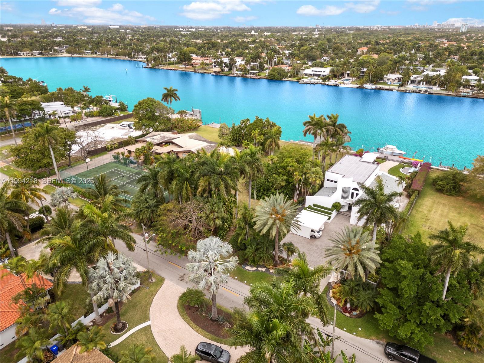 An aerial view shows a waterfront house with a tennis court and palm trees — 1018 S Northlake Dr, Hollywood FL 33019, HOLLYWOOD, FL