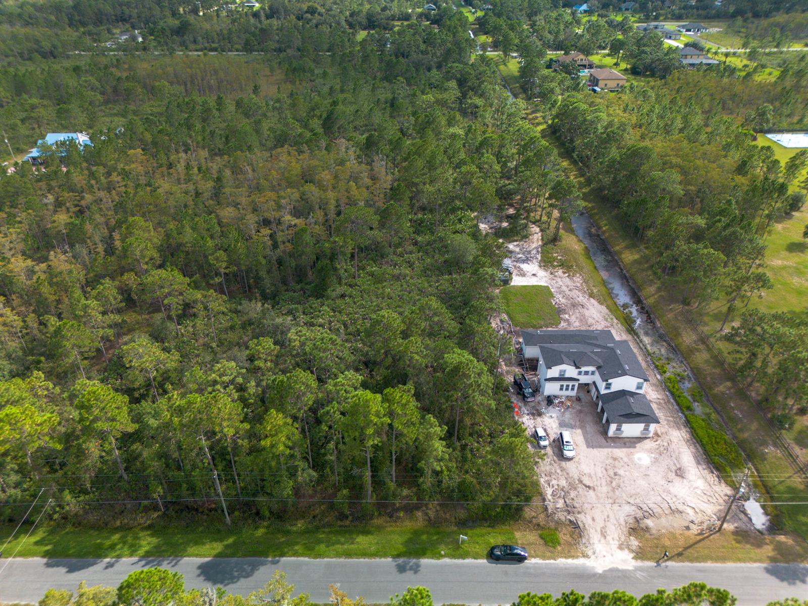 An aerial view shows a newly constructed house situated on a large, wooded lot — 0 Sabal Street, Orlando FL 32833, ORLANDO, FL
