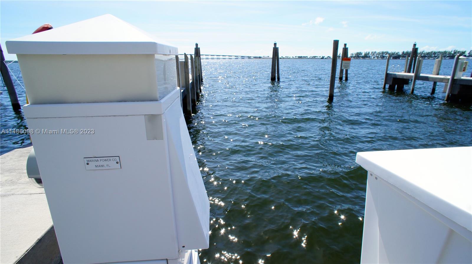A white marina power pedestal stands on a dock overlooking a body of water — 1643 Brickell Slip #5, Miami FL 33129, MIAMI, FL