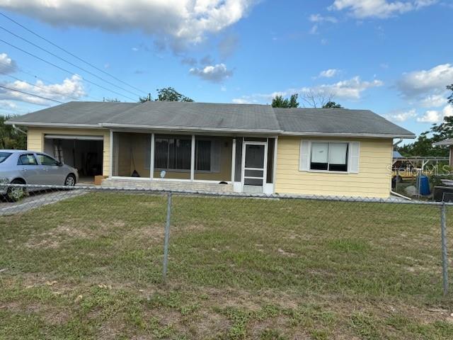 A single-story yellow house with a gray roof and an attached garage sits behind a fence — 499 WATER ROAD, OCALA, FL