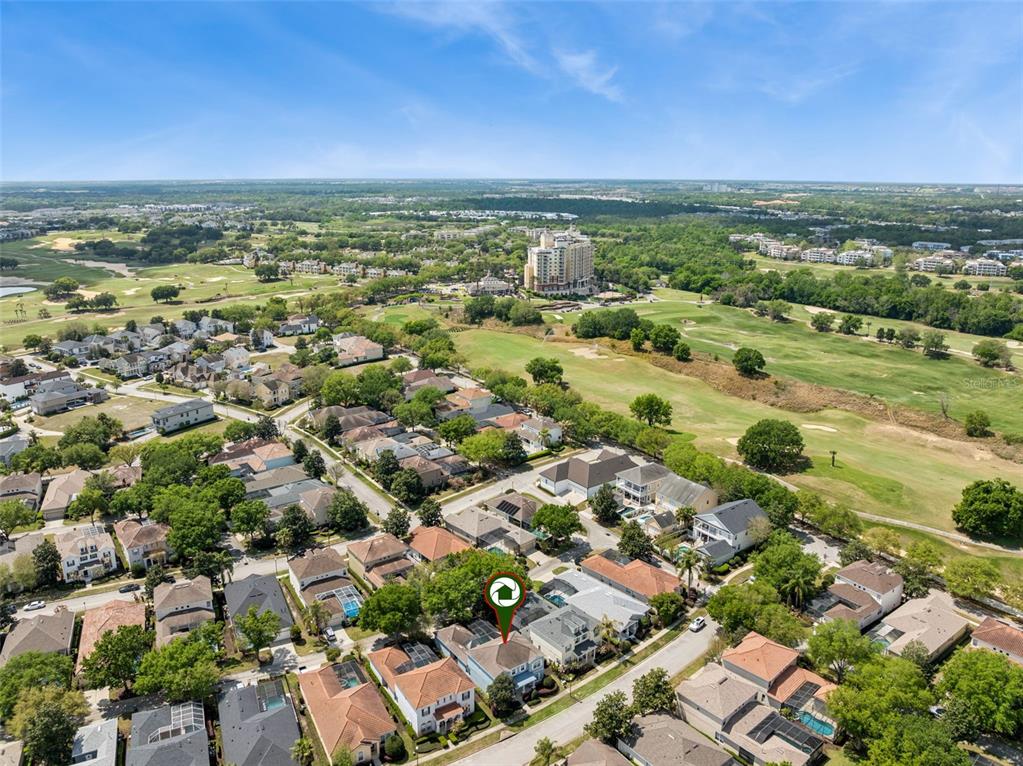 An aerial view shows a residential neighborhood with houses, a golf course, and a large hotel — 7412 DEVEREAUX STREET, KISSIMMEE, FL
