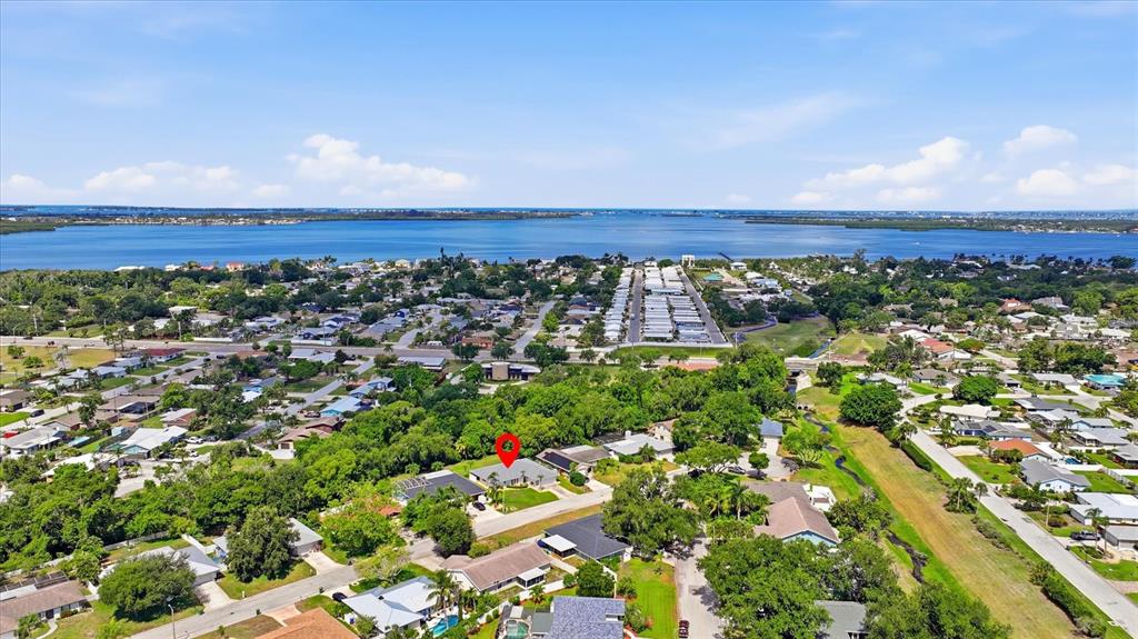 An aerial view shows a residential neighborhood near a large body of water — 2130 72ND STREET CIRCLE W, BRADENTON, FL