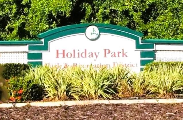 A sign for Holiday Park Park & Recreation District stands in front of green trees — 5420 HOLIDAY PARK BOULEVARD, NORTH PORT, FL