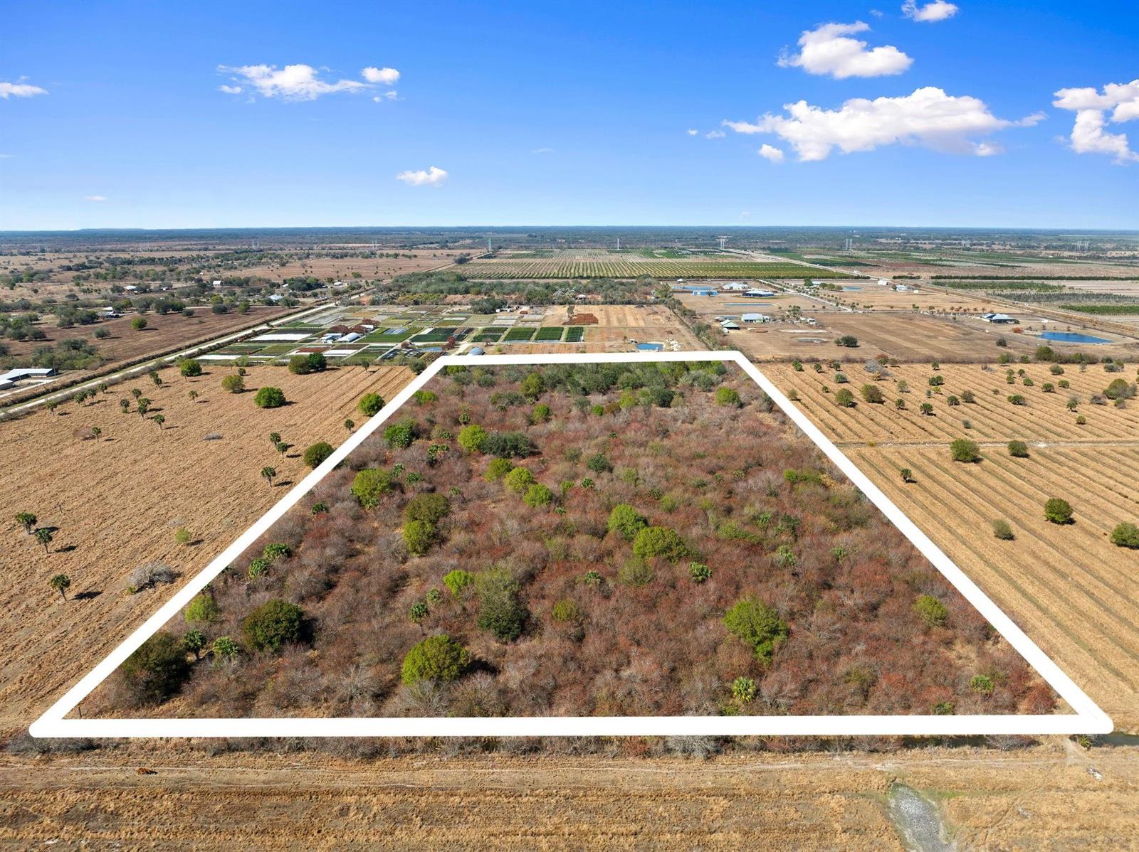 An aerial view shows a rectangular plot of land covered in trees and brush — Kelly Road, Fort Pierce FL 34945, FORT PIERCE, FL
