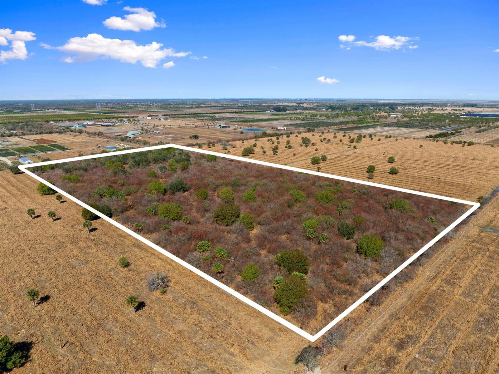 An aerial view shows a rectangular plot of land outlined in white amidst dry fields — Kelly Road, Fort Pierce FL 34945, FORT PIERCE, FL