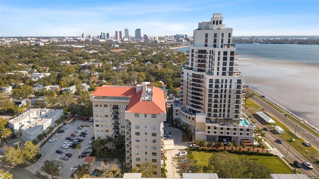 An aerial view shows several multi-story apartment buildings near a body of water — 2109 BAYSHORE BOULEVARD UNIT 205, TAMPA, FL
