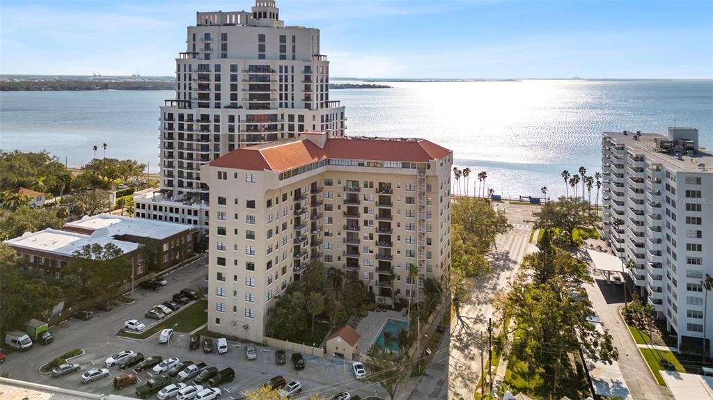 An aerial view shows two large apartment buildings situated near a body of water — 2109 BAYSHORE BOULEVARD UNIT 205, TAMPA, FL