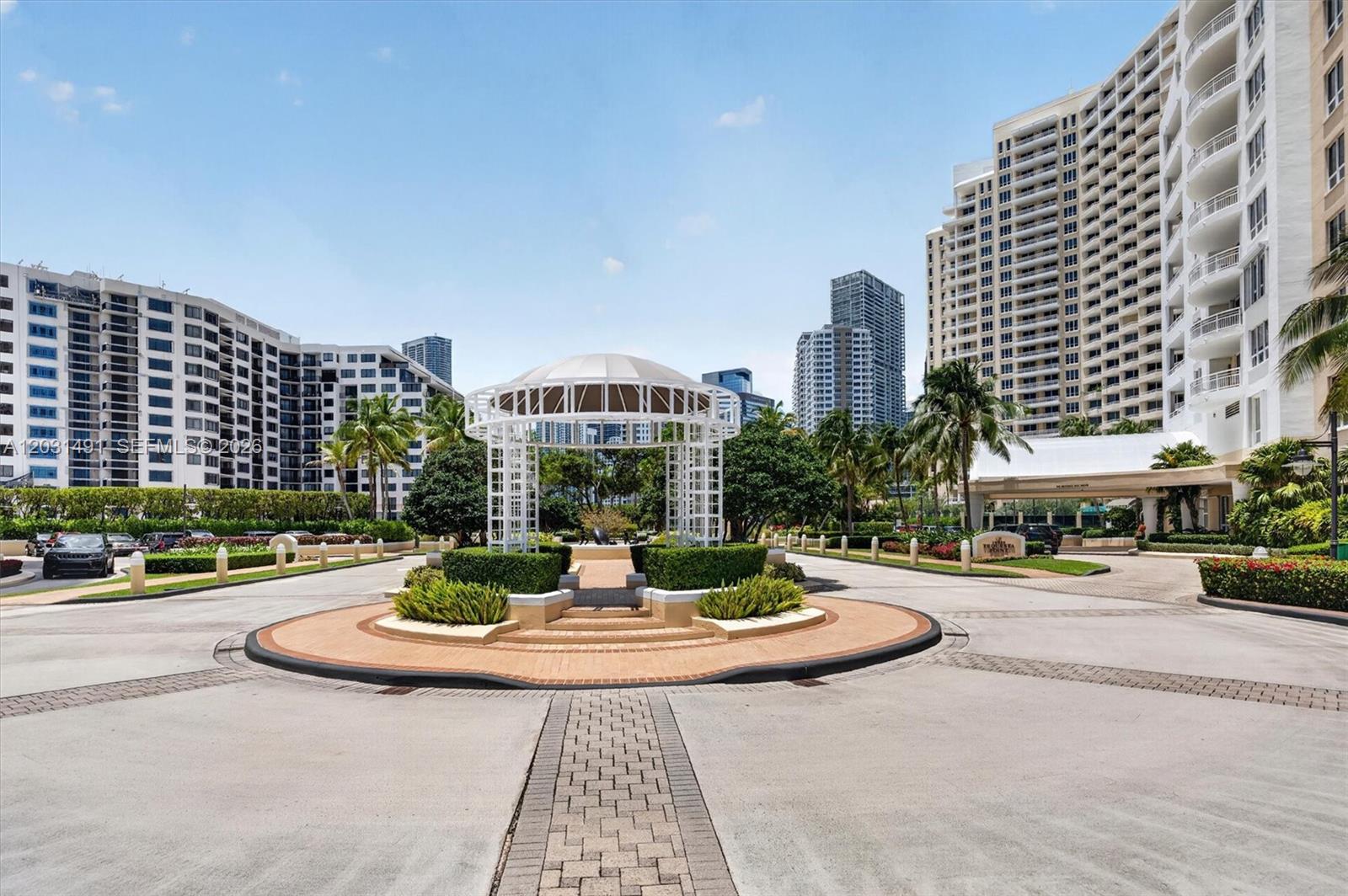 An aerial view shows three tall residential towers situated on a waterfront point — 848 Brickell Key Dr # 3402, Miami FL 33131, MIAMI, FL