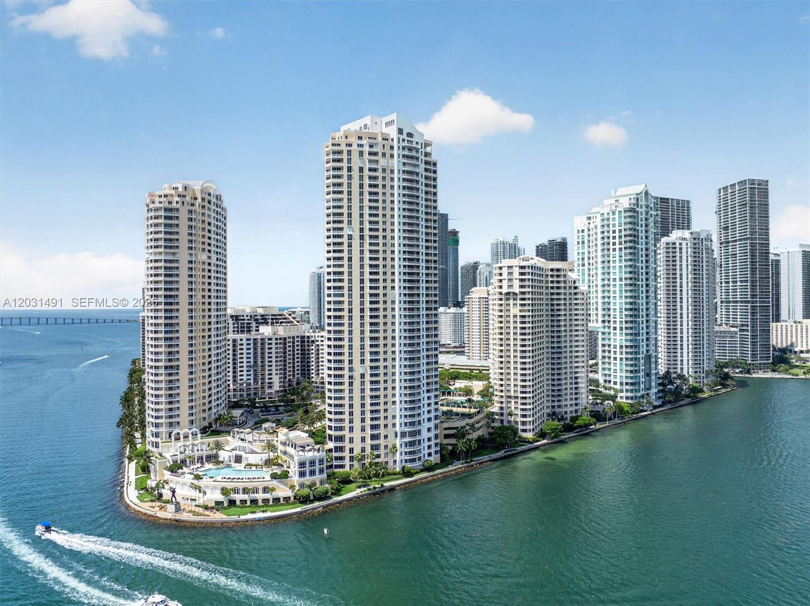 A white gazebo sits in the center of a circular driveway surrounded by tall buildings — 848 Brickell Key Dr # 3402, Miami FL 33131, MIAMI, FL
