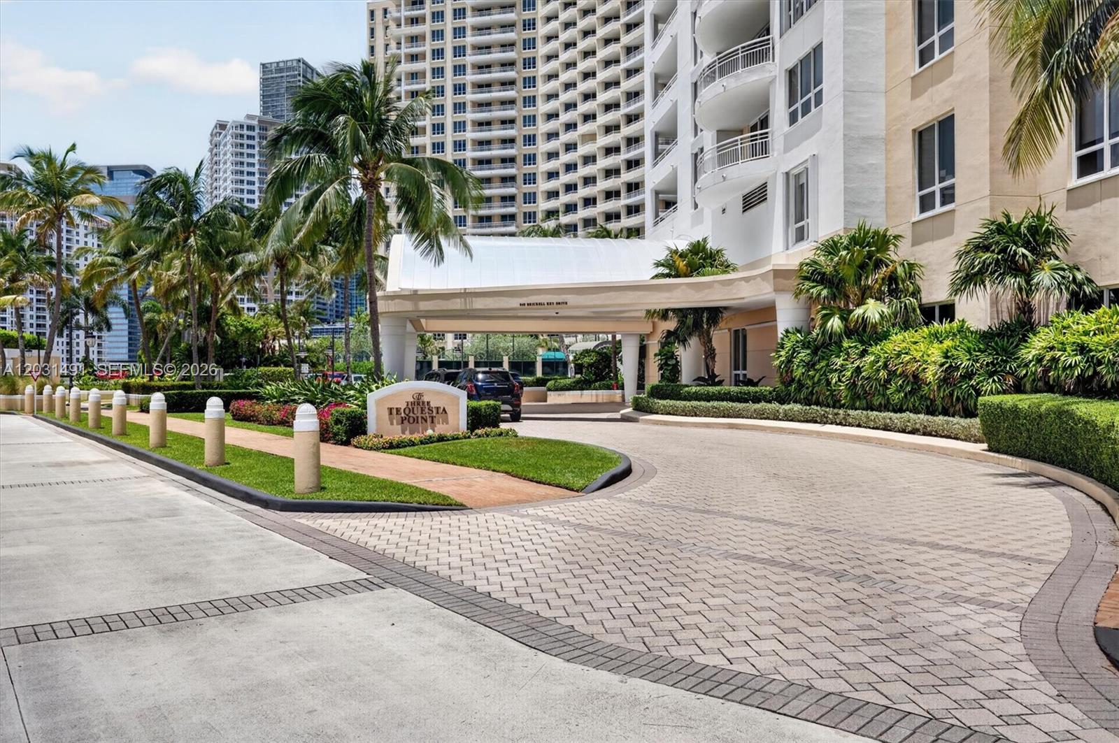 An aerial view shows several high-rise residential towers situated on a waterfront peninsula — 848 Brickell Key Dr # 3402, Miami FL 33131, MIAMI, FL
