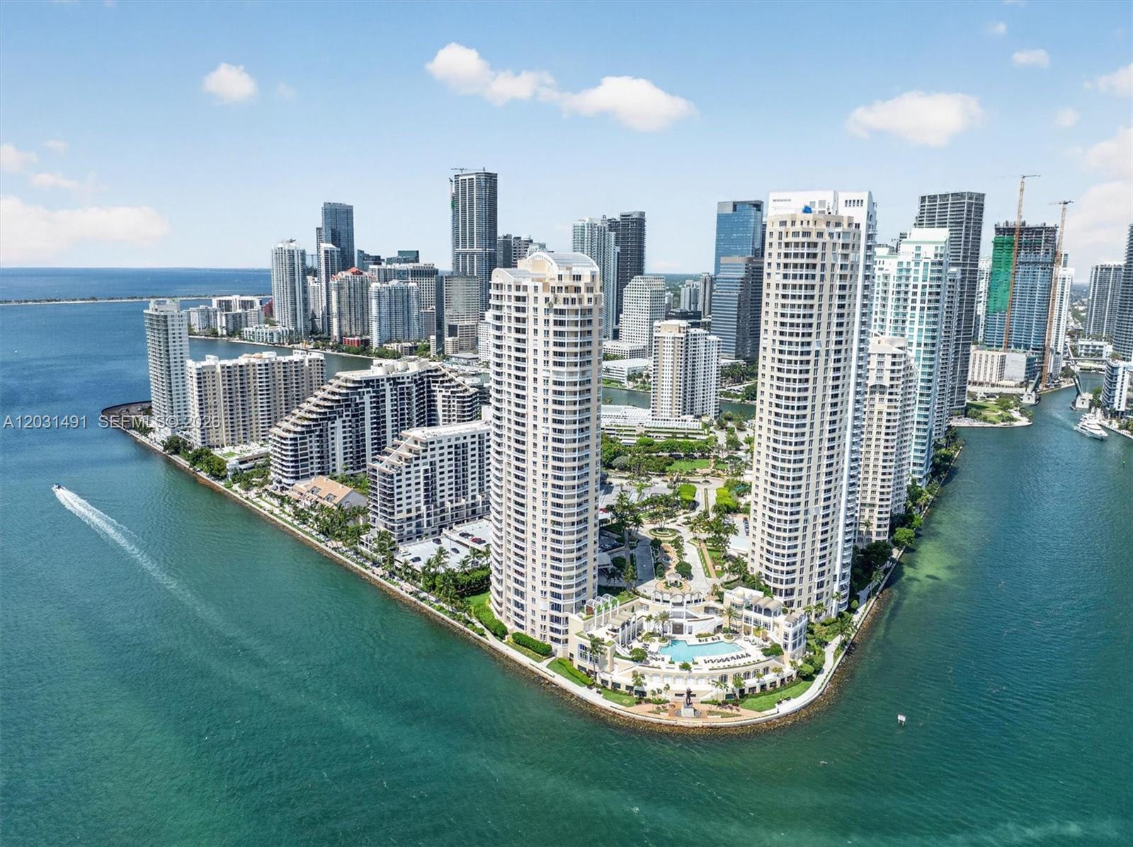 The exterior entrance of a high-rise residential building features a paved driveway and landscaping — 848 Brickell Key Dr # 3402, Miami FL 33131, MIAMI, FL