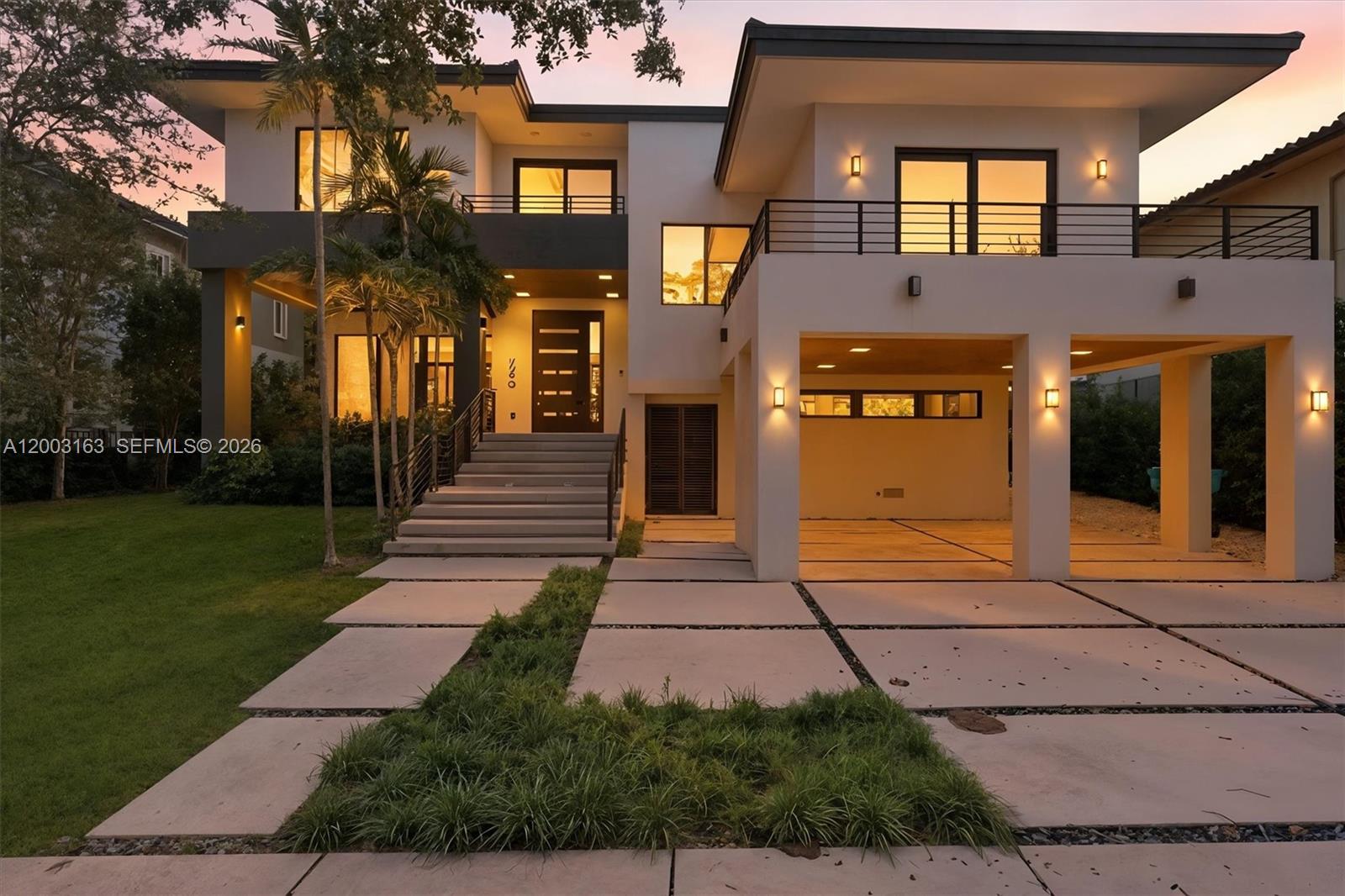 A modern two-story house features a covered garage, elevated entryway stairs, and a balcony — 760 Woodcrest Rd, Key Biscayne FL 33149, KEY BISCAYNE, FL