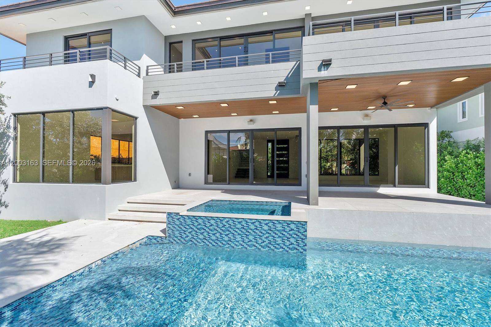 A modern two-story house features a swimming pool, a raised spa, and a covered patio — 760 Woodcrest Rd, Key Biscayne FL 33149, KEY BISCAYNE, FL