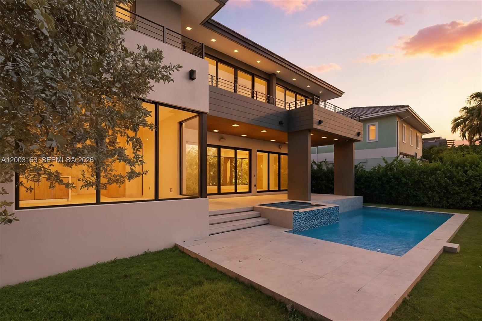 A modern two-story house features a swimming pool, a hot tub, and large glass windows — 760 Woodcrest Rd, Key Biscayne FL 33149, KEY BISCAYNE, FL