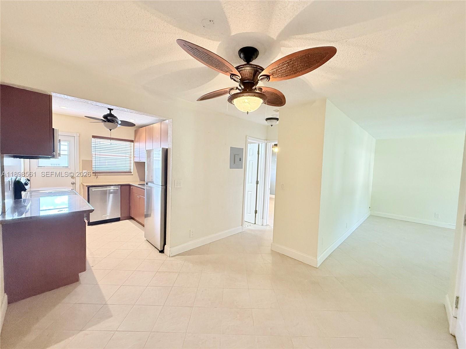 This interior view shows a kitchen with tile flooring, stainless appliances, and a ceiling fan — 3600 Harrison St # 16B, Hollywood FL 33021, HOLLYWOOD, FL