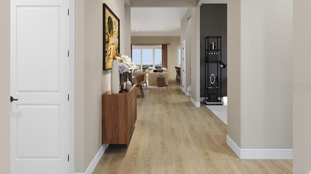 This virtually staged rendering shows a hallway leading into an open-concept living area — 26431 ARGUS PLACE, PUNTA GORDA, FL