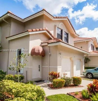 A two-story beige stucco townhouse with a tiled roof and an attached garage — 8711 Via Giula # 2, Boca Raton FL 33496, BOCA RATON, FL