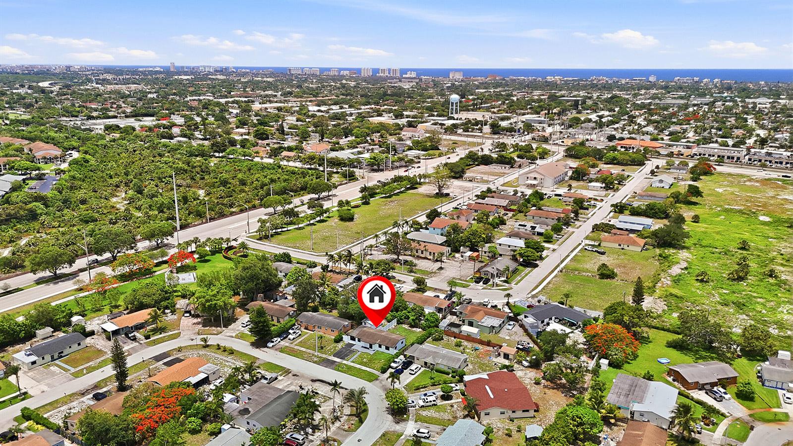 An aerial view shows a residential neighborhood with a red house icon marking a property — 1060 SW 5th Terrace, Deerfield Beach FL 33441, DEERFIELD BEACH, FL