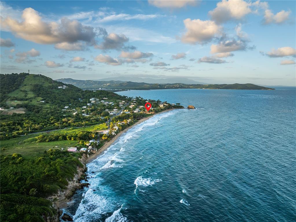 An aerial view shows a coastal property marked with a red pin along a beach — Parcela #10 BARRIO CAMINO NUEVO, YABUCOA, PR