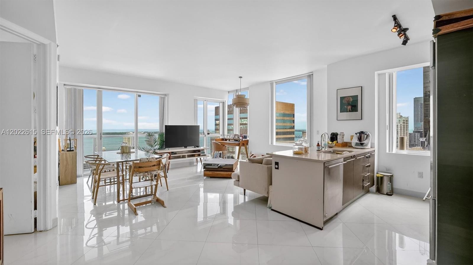 An open-concept living area features white tile floors, a kitchen island, and floor-to-ceiling windows — 500 Brickell Ave # 4102, Miami FL 33131, MIAMI, FL