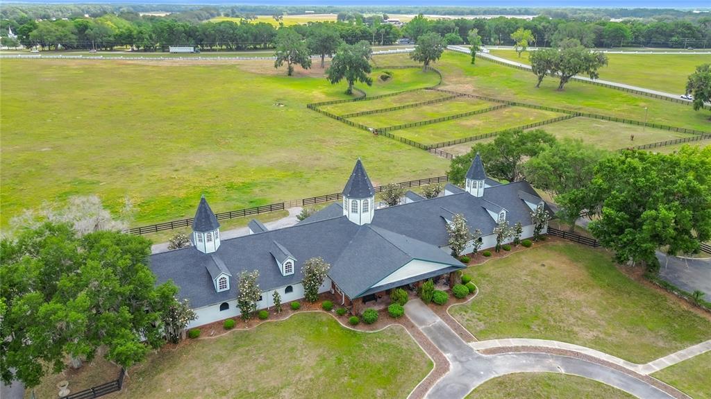 An aerial view of a large, single-story house with multiple turrets and a sprawling lawn — 6530 SE 156TH LOOP UNIT 3 & 4, SUMMERFIELD, FL