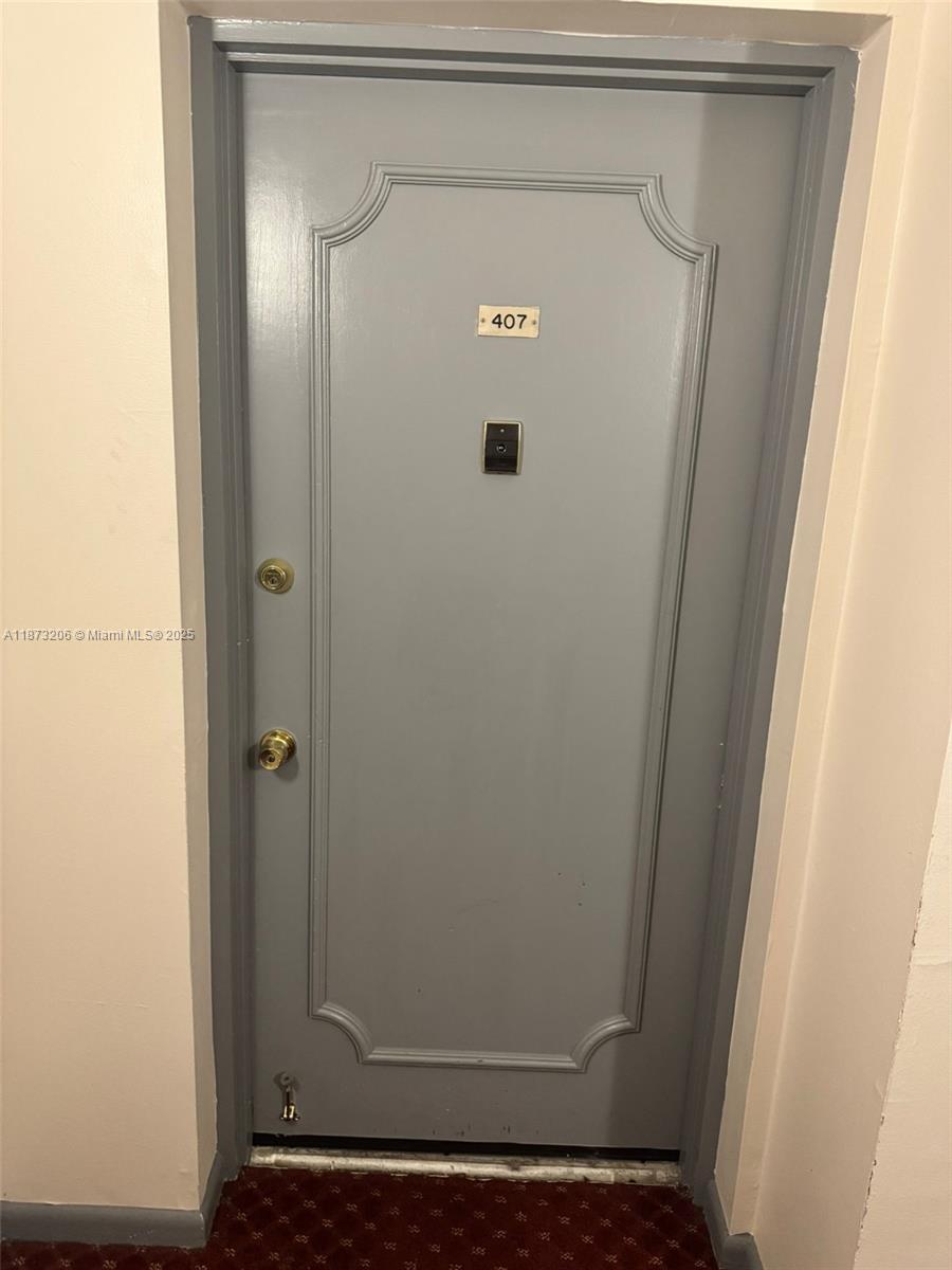 A gray apartment door with a number 407 plaque and gold hardware — 2061 NW 47th Ter # 407, Lauderhill FL 33313, LAUDERHILL, FL