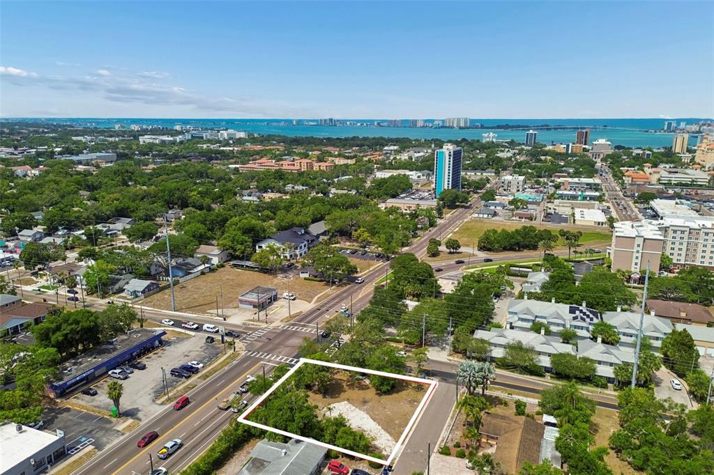 An aerial view shows a vacant rectangular lot outlined in white near a busy intersection — 1107 BROWNELL STREET, CLEARWATER, FL