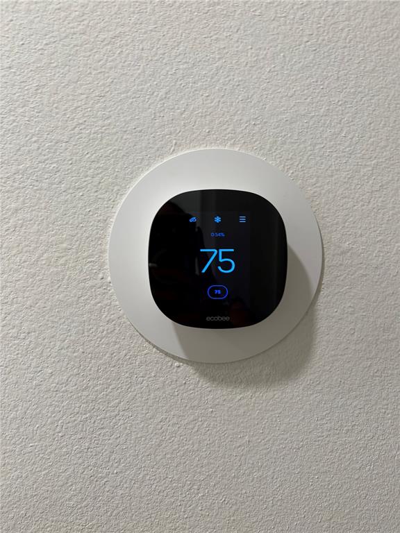 A wall-mounted ecobee smart thermostat is displayed against a textured white wall — 1492 MIRABELLA CIRCLE, DAVENPORT, FL