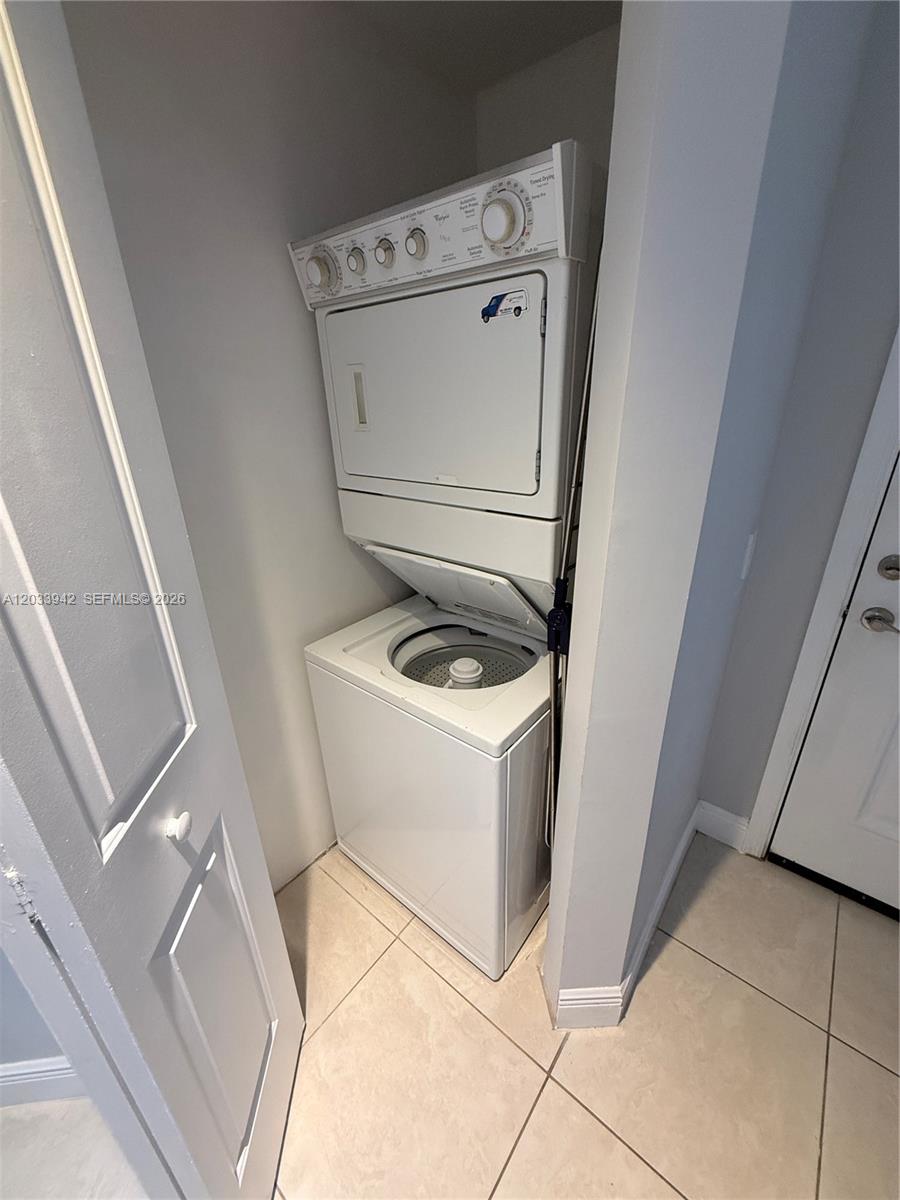 A stacked washer and dryer unit is installed in a small laundry closet — 480 NE 30th St # 1504, Miami FL 33137, MIAMI, FL