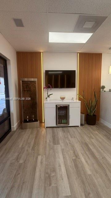 A waiting area features wood slat wall panels, a water feature, a television, and cabinetry — 119 N POWERLINE RD # 119, Deerfield Beach FL 33442, DEERFIELD BEACH, FL