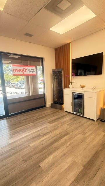 A waiting room features wood-look flooring, a water feature, a beverage cooler, and a television — 119 N POWERLINE RD # 119, Deerfield Beach FL 33442, DEERFIELD BEACH, FL
