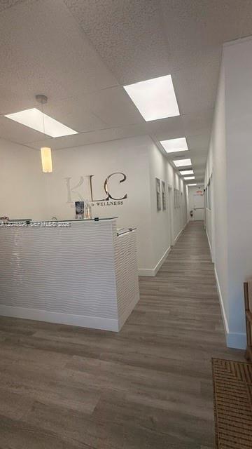 A reception desk with a white textured front sits in a bright office hallway — 119 N POWERLINE RD # 119, Deerfield Beach FL 33442, DEERFIELD BEACH, FL
