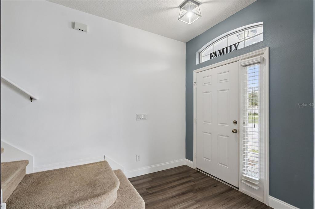 A two-story house with a gray stucco exterior, dark trim, and a two-car garage — 3016 SUNSCAPE TERRACE, GROVELAND, FL