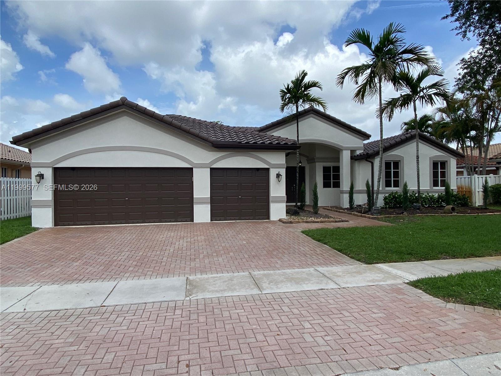 A single-story house features a two-car garage, a tiled roof, and a paved driveway — 4000 SW 145th Ave, Miramar FL 33027, MIRAMAR, FL