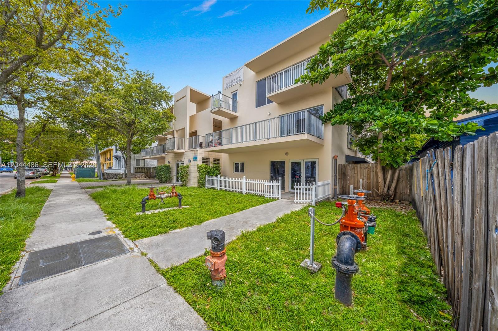 The exterior of a multi-story apartment building features balconies and several fire department water connections — 1553 SW 2nd St, Miami FL 33135, MIAMI, FL